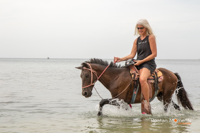 Girl with horse on the beach